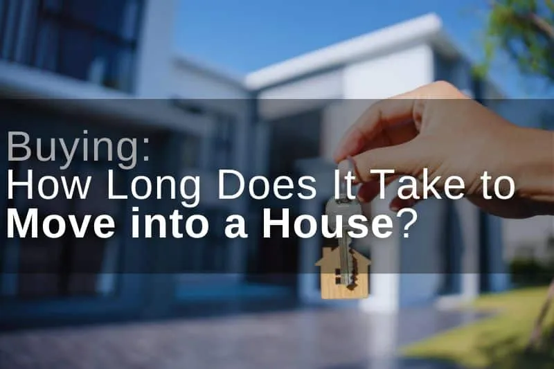 How long does it take to move into a house? A new homeowner holding their house keys in front of the house.